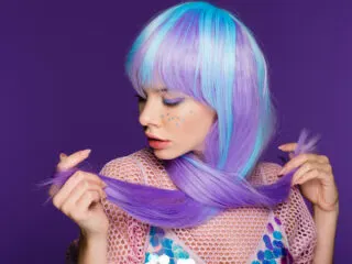 cute girl in a purple and blue wig wants to connect to the universe testing.