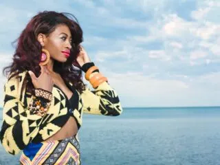 beautiful black woman in colorful african print on the beach