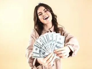 happy woman showing manifested cash money