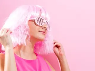 pink woman in pink glasses on pink background